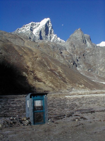 A lone mountain outhouse.