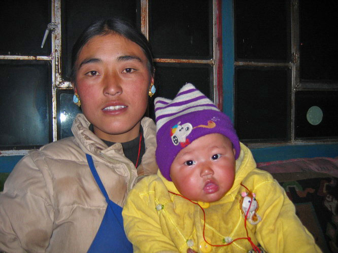 A friend with her baby from the Everest View hotel. Tingre, Central Tibet.