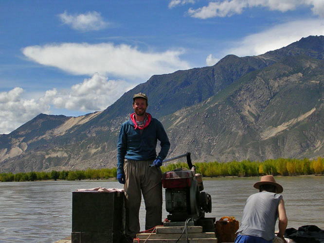 Ray piloting a ferry across the Brahmaputra, near Samye, Tibet.