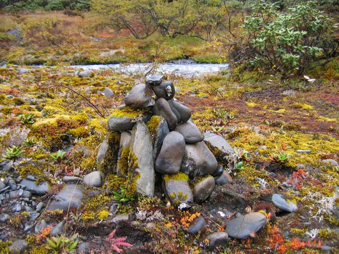 A small pile of offering stones on the trail side.