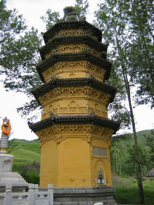 A large pagota in a cemetery.