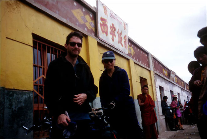 Spectators look in as we stop for a little food shopping and a break in Amdo. Qhinghai, China.