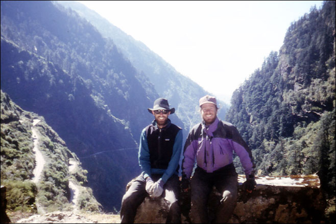 As we descend lower the hillsides are covered in dense forest. Nyalam, Tibet.