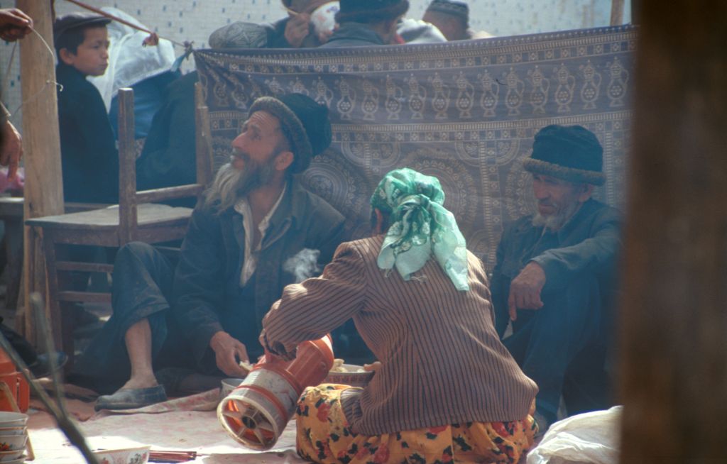 Pouring some hot water for a cup of "wanza", tea with large chunks of rock candy sugar inside. Yum... Kashgar, Xinjiang, China.