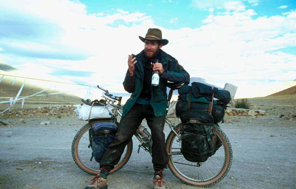 John, trying to blend in with the local truck drivers, a cigarette in one hand and a bottle bear in the other. Saga, Tibet.
