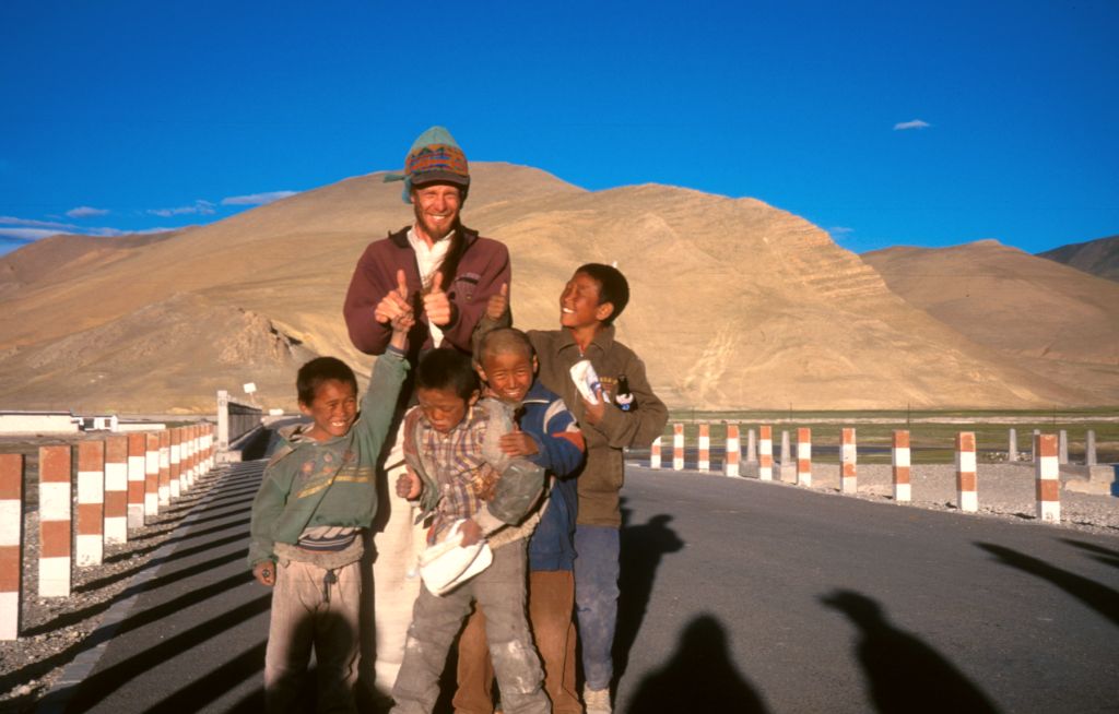 This thumbs up sign is used by beggars and kids to mean 'please'. "Please, please give us sometime thing..." 